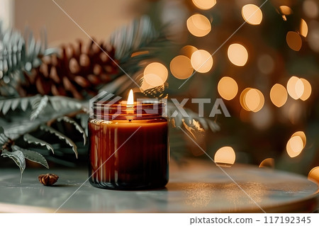 A cozy candle is surrounded by pine cones with Christmas lights, creating a warm festive atmosphere A cozy candle is surrounded by pine cones with Christmas lights, creating a warm festive atmosphere 117192345
