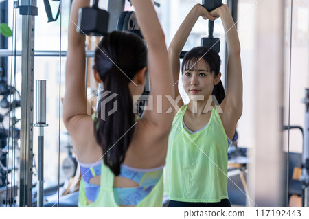 Young woman training in a sports gym Young woman training in a sports gym 117192443