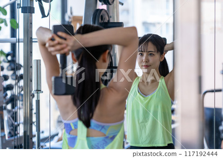 Young woman training in a sports gym Young woman training in a sports gym 117192444
