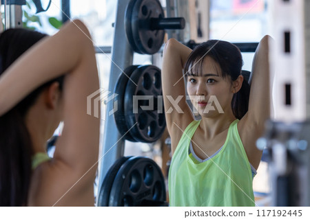 Young woman training in a sports gym 117192445