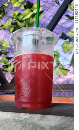 Close-up shot of watermelon juice in a plastic cup 117192446