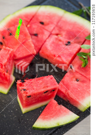 pieces of ripe red watermelon, close-up, on a board pieces of ripe red watermelon, close-up, on a board 117193658