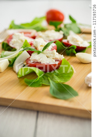tomato wedges with cottage cheese filling and garlic, spicy appetizer tomato wedges with cottage cheese filling and garlic, spicy appetizer 117193716