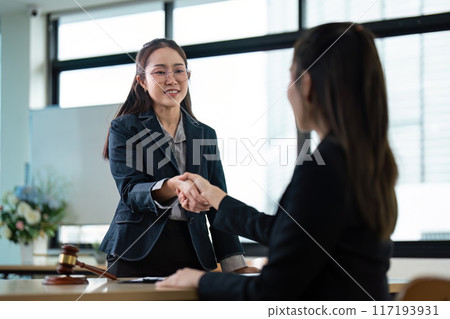 Professional Female Lawyer Shaking Hands with Client in Modern Office Setting, Legal Consultation and Agreement Concept Professional Female Lawyer Shaking Hands with Client in Modern Office Setting, Legal Consultation and Agreement Concept 117193931