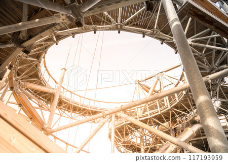 A close-up view of the Sky Walk Tower's intricate structure, showcasing the wooden planks and metal supports. Swieradow Zdroj, Poland A close-up view of the Sky Walk Tower's intricate structure, showcasing the wooden planks and metal supports. Swieradow Zdroj, Poland 117193959