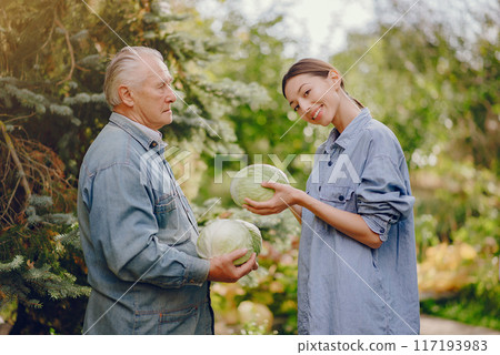 Senior with green gabbage. Brunette in a blue shirt. Grandfather with grandaughter. Senior with green gabbage. Brunette in a blue shirt. Grandfather with grandaughter. 117193983