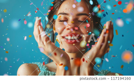 Smiling Woman Celebrating with Colorful Confetti 117194160