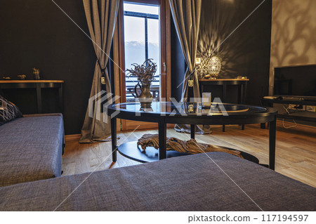 Bohemian living room in warm colors with various decorative elements, interior design Bohemian living room in warm colors with various decorative elements, interior design 117194597
