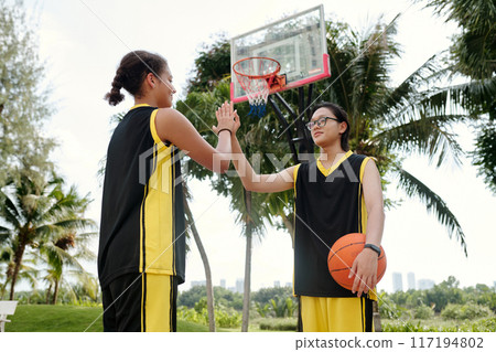 Celebrating Success Holding Basketball in Tropical Setting Celebrating Success Holding Basketball in Tropical Setting 117194802