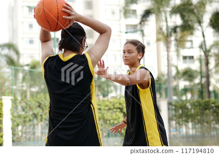 Playing Basketball Outdoors in Training Session Game 117194810
