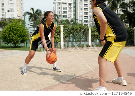 Two Adolescent Basketball Players Outdoors Interacting Two Adolescent Basketball Players Outdoors Interacting 117194849