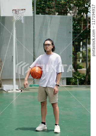 Playing Basketball on Outdoor Court Holding Basketball Playing Basketball on Outdoor Court Holding Basketball 117194917