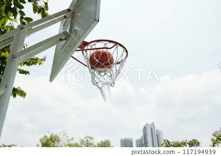 Basketball Going Through Urban Basketball Hoop Outside Basketball Going Through Urban Basketball Hoop Outside 117194939