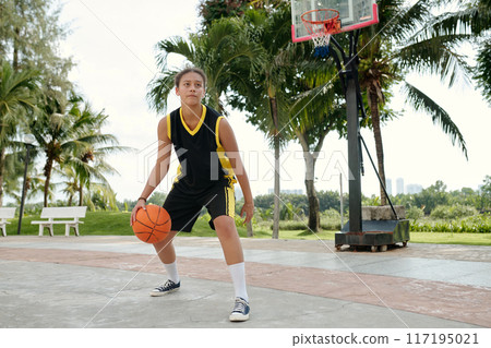 Practicing Basketball Outdoors Under Palm Trees 117195021