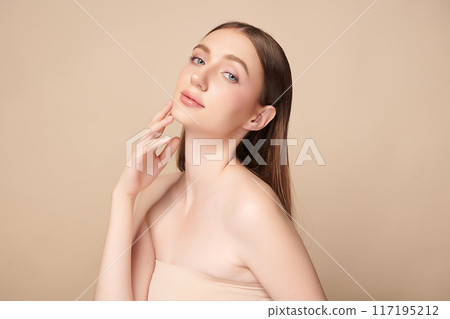 Beautiful young woman with clean fresh skin on beige background, Face care, Facial treatment, Cosmetology, beauty and spa, women portrait. 117195212