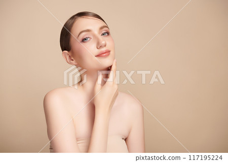 Beautiful young woman with clean fresh skin on beige background, Face care, Facial treatment, Cosmetology, beauty and spa, women portrait. 117195224