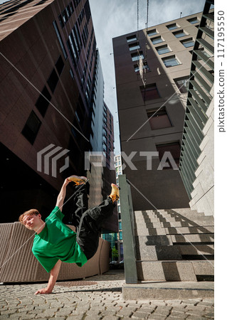 Parkrun enthusiast, dressed colorful clothes leaps mid-air against urban backdrop, embodying joy and energy of community run. 117195550