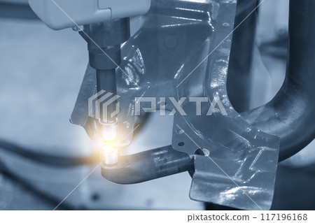 The automotive parts spot welding process by robotic system in the light blue scene with lighting effect. 117196168