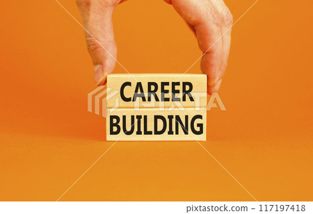 Career building symbol. Concept words Career building on beautiful wooden block. Beautiful orange table orange background. Businessman hand. Business, motivational career building concept. Copy space. 117197418