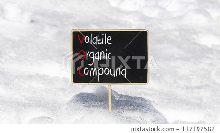 VOC volatile organic compound symbol. Concept words VOC volatile organic compound on beautiful yellow blackboard. Beautiful snow background. Business VOC volatile organic compound concept. Copy space 117197582