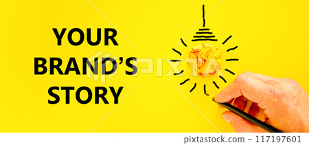 Branding and your brand story symbol. Concept words Your brands story on beautiful yellow paper. Beautiful yellow background. Businessman hand. Business branding your brand story concept. Copy space. Branding and your brand story symbol. Concept words Your brands story on beautiful yellow paper. Beautiful yellow background. Businessman hand. Business branding your brand story concept. Copy space. 117197601