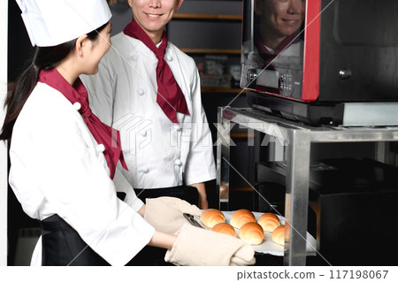 Smiling Asian man and woman making bread in the kitchen Smiling Asian man and woman making bread in the kitchen 117198067