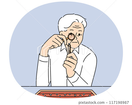 Elderly man jeweler examines diamond through magnifying glass checking gems for authenticity Elderly man jeweler examines diamond through magnifying glass checking gems for authenticity 117198987