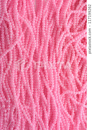 Full frame of pink beads on fishing line as background or texture. 117199262