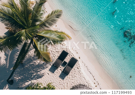 Sun lounger on the beach with palm trees and deep turquoise sea Sun lounger on the beach with palm trees and deep turquoise sea 117199493