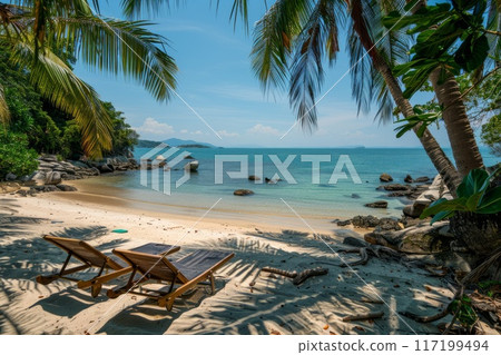 Sun lounger on the beach with palm trees and deep turquoise sea Sun lounger on the beach with palm trees and deep turquoise sea 117199494