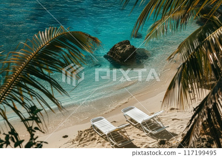 Sun lounger on the beach with palm trees and deep turquoise sea 117199495