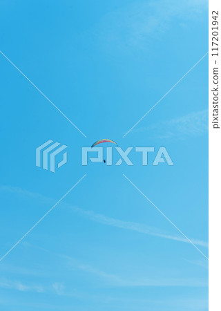Paraglider in the air fly in blue clear summer sky. 117201942