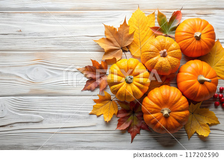 Autumn pumpkins and leaves on a wooden background, space for text Thanksgiving concept Autumn pumpkins and leaves on a wooden background, space for text Thanksgiving concept 117202590