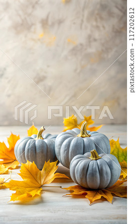 Autumn white pumpkins and leaves on a bright background, space for text Thanksgiving concept 117202612