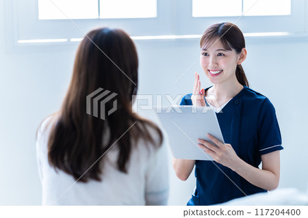 Female staff providing counseling at a beauty clinic Female staff providing counseling at a beauty clinic 117204400