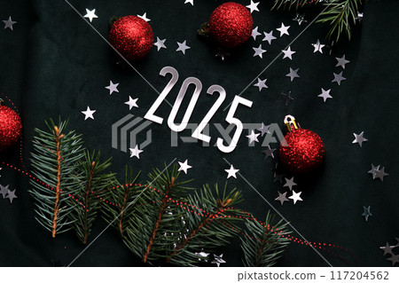 New Year 2025 dark background. Number of the coming year in Christmas decoration. New Year 2025 dark background. Number of the coming year in Christmas decoration. 117204562
