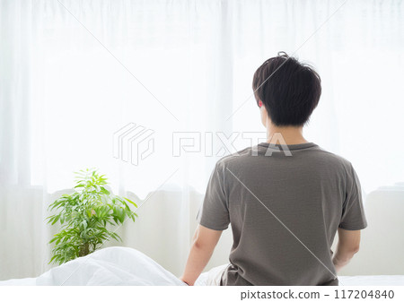 Image of a man waking up in the morning and a refreshing room Image of a man waking up in the morning and a refreshing room 117204840