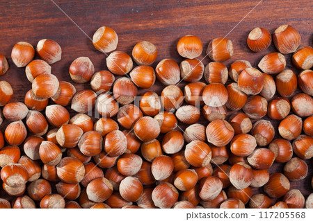 Image of dry unpeeled walnut on wooden surface, nobody Image of dry unpeeled walnut on wooden surface, nobody 117205568