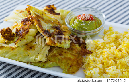 Cabbage in batter with rice and sauces Cabbage in batter with rice and sauces 117205642