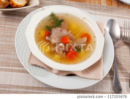 Fresh portion of meat soup served in bowl 117205676