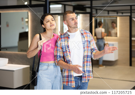 Husband and wife choosing bathroom accessories together at hardware store Husband and wife choosing bathroom accessories together at hardware store 117205725