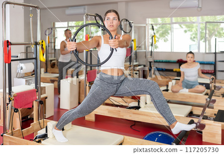 Young woman exercising with pilates ring Young woman exercising with pilates ring 117205730