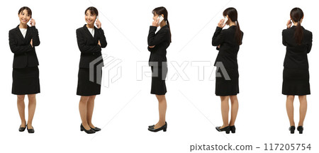 Full-body cutout of a businesswoman making a phone call on her smartphone 117205754