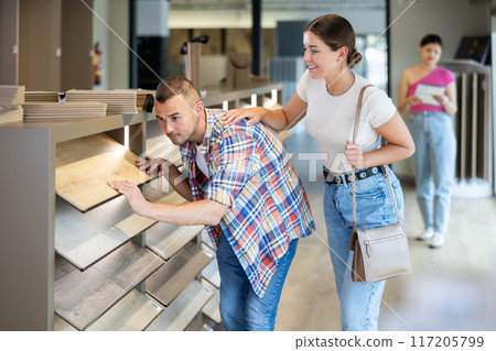 Couple man and woman choosing laminate flooring Couple man and woman choosing laminate flooring 117205799