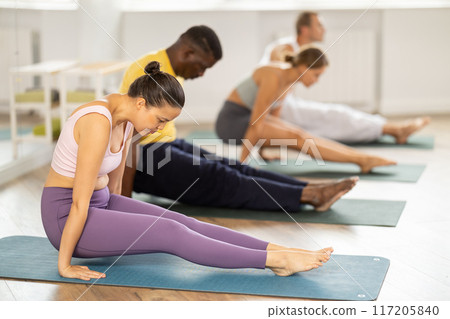 Pilates classes for men and women of different nationalities and ages. Hand balancing 117205840