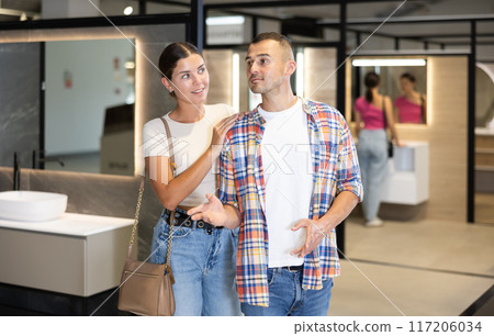 Man and woman looking around in bathroom department of store 117206034