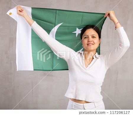 Young woman posing in studio with Pakistan flag 117206127