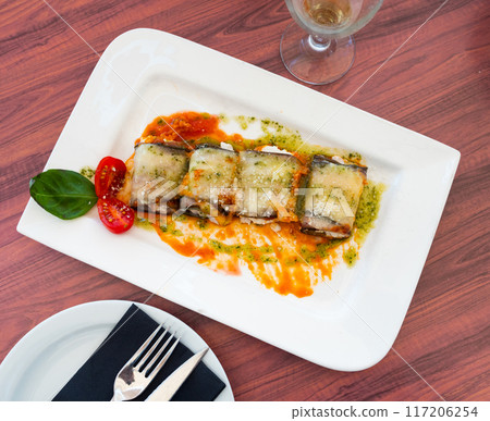 Stuffed eggplants with sauce served on platter Stuffed eggplants with sauce served on platter 117206254