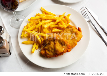 Dish of Spanish cuisine is goat cheese and pepper booklets with French fries Dish of Spanish cuisine is goat cheese and pepper booklets with French fries 117206356