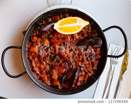 Paella marinera with shrimps and mussels served on iron frypan Paella marinera with shrimps and mussels served on iron frypan 117206380